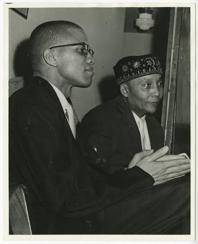 Malcolm X and Elijah Muhammad seated together during Malcolm's rise in the Nation. Photographer unknown.