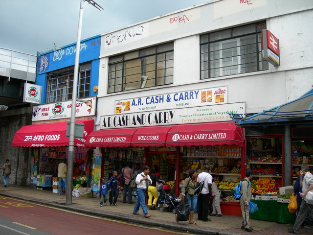 Food shops and shoppers on Rye Lane, Peckham, August 19, 2006. This later photograph shows the African and Caribbean retail life carried forward in the neighborhood, not a scene from 1981. Photograph: Danny Robinson, Geograph/Wikimedia Commons; CC BY-SA 2.0, unchanged.