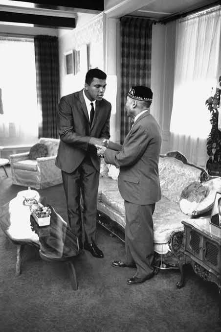 Muhammad Ali greets Elijah Muhammad at the Messenger's home. Photographer unknown.