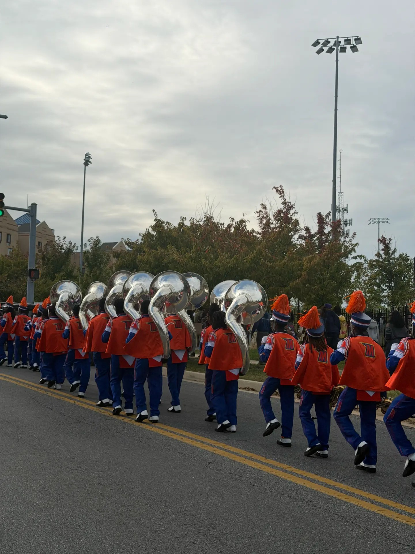 Morgan’s brass section and orange plumes fill the street. Photo: Morgan Hall, MPH.